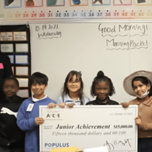Junior Achievement receives a $15,000 donation from Populus Financial Group, and volunteers teach the programme for a day.